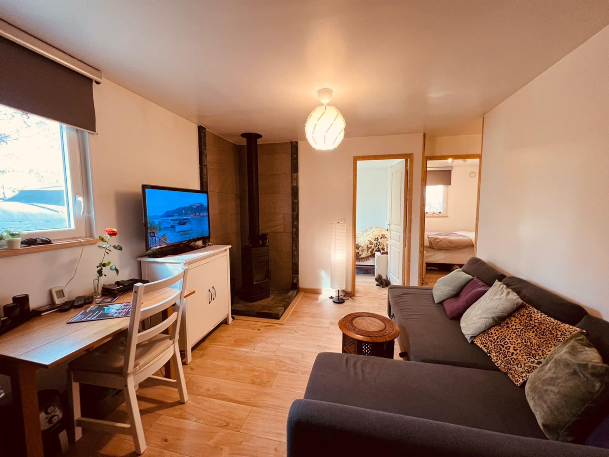 Lodge living area with sofa, TV and wood burner